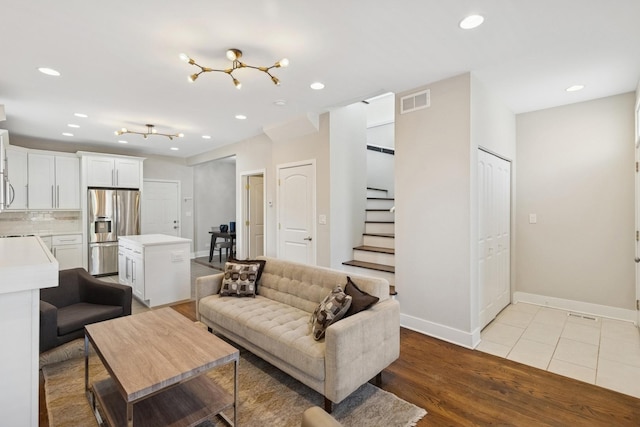2415 W Washburne Ave, Chicago, IL 60608 - living room featuring baseboards, stairway, recessed lighting, and light wood finished floors