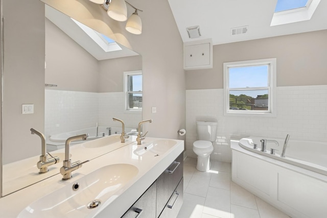 2415 W Washburne Ave, Chicago, IL 60608 - bathroom with a skylight, tile walls, tile patterned flooring, plenty of natural light, and a garden tub