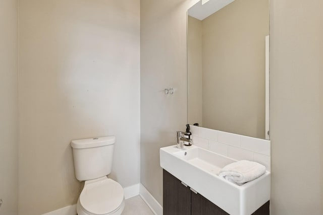 2415 W Washburne Ave, Chicago, IL 60608 - bathroom featuring baseboards, toilet, and vanity