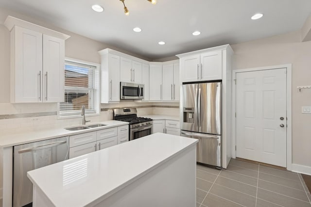 2415 W Washburne Ave, Chicago, IL 60608 - kitchen featuring stainless steel appliances, a sink, tasteful backsplash, white cabinets, and recessed lighting