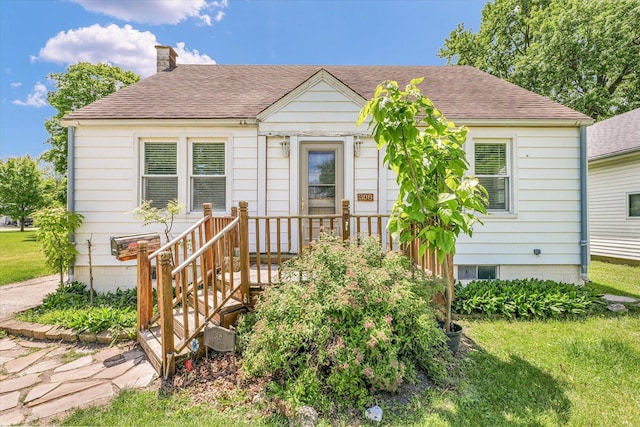 308 W Spruce St, Paxton, IL 60957 - bungalow featuring a chimney, roof with shingles, and a front lawn
