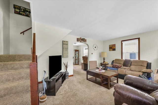 308 W Spruce St, Paxton, IL 60957 - living room featuring arched walkways, carpet flooring, and stairway
