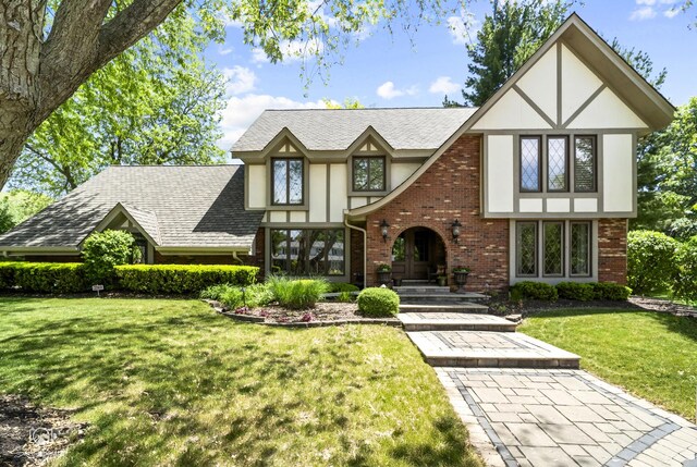 3302 Kingswood Ct, Joliet, IL 60431 - tudor home with stucco siding, a front lawn, brick siding, and roof with shingles