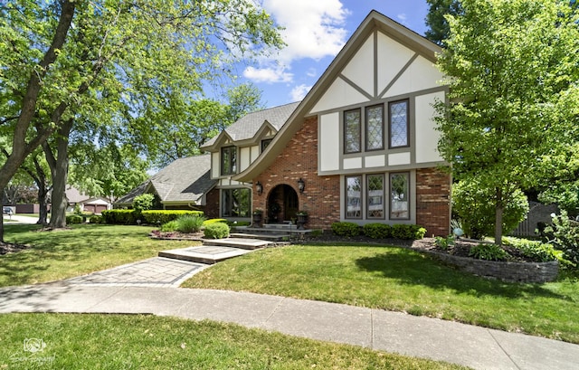 3302 Kingswood Ct, Joliet, IL 60431 - tudor-style house with brick siding, a front yard, and stucco siding