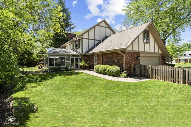 3302 Kingswood Ct, Joliet, IL 60431 - rear view of house featuring a sunroom, brick siding, roof with shingles, a chimney, and an attached garage