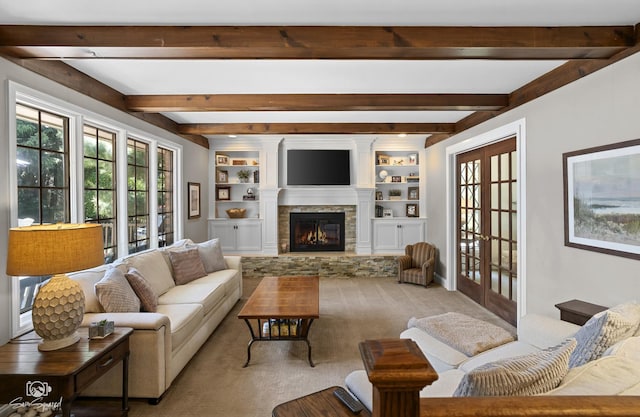 3302 Kingswood Ct, Joliet, IL 60431 - living room featuring a stone fireplace, carpet flooring, beam ceiling, built in shelves, and french doors