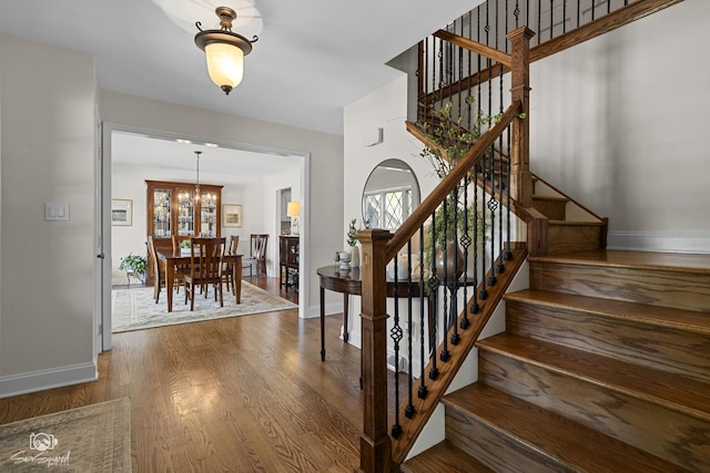 3302 Kingswood Ct, Joliet, IL 60431 - stairway with a chandelier, wood finished floors, baseboards, and healthy amount of natural light