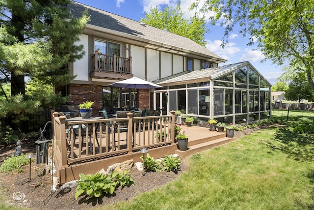 3302 Kingswood Ct, Joliet, IL 60431 - back of property with a sunroom, a shingled roof, a wooden deck, brick siding, and outdoor dining space