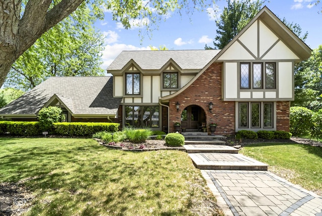 3302 Kingswood Ct, Joliet, IL 60431 - tudor house with stucco siding, brick siding, a front lawn, and roof with shingles