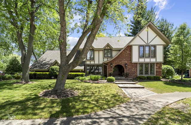 3302 Kingswood Ct, Joliet, IL 60431 - tudor house with brick siding, a front yard, stucco siding, and roof with shingles