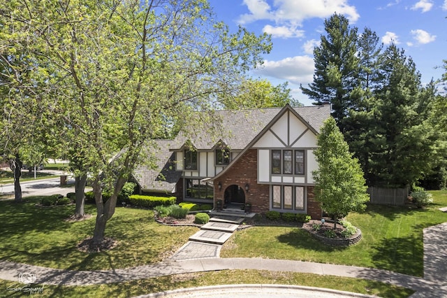 3302 Kingswood Ct, Joliet, IL 60431 - tudor-style house featuring stucco siding, a front yard, and brick siding