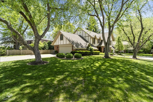 3302 Kingswood Ct, Joliet, IL 60431 - tudor house with brick siding, board and batten siding, an attached garage, and roof with shingles