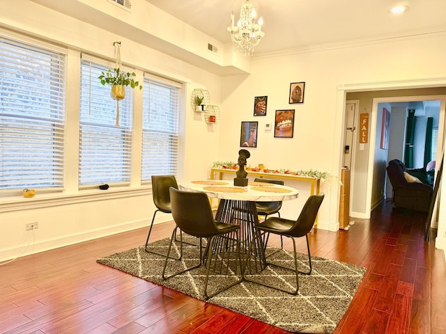 6228 N Artesian Ave, Chicago, IL 60659 - dining area featuring dark wood-type flooring, baseboards, a chandelier, and crown molding