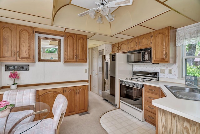 75 Largemouth Ln, Wilmington, IL 60481 - kitchen featuring white gas range oven, black microwave, a sink, and light countertops