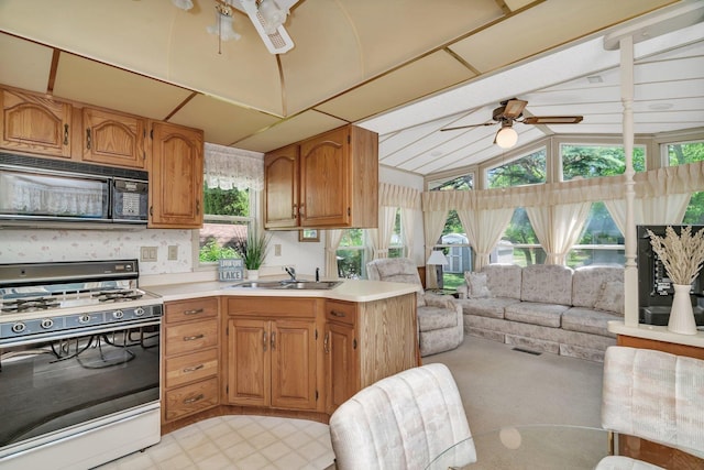 75 Largemouth Ln, Wilmington, IL 60481 - kitchen with range with gas cooktop, black microwave, a sink, open floor plan, and lofted ceiling