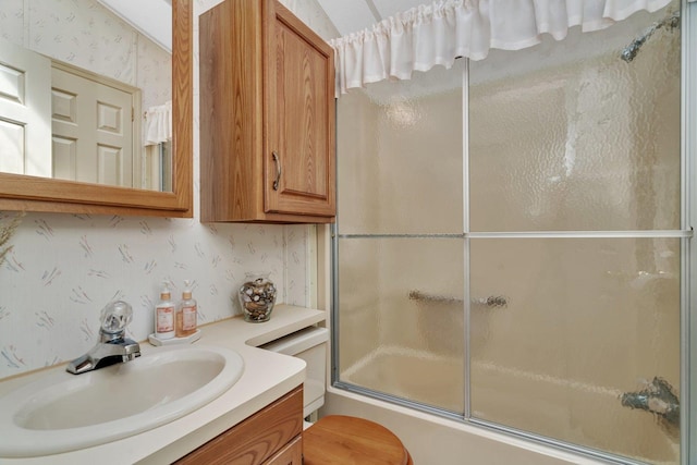 75 Largemouth Ln, Wilmington, IL 60481 - bathroom featuring wallpapered walls, shower / bath combination with glass door, vanity, and toilet