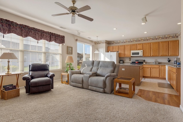 12183 Wildflower Ln, Huntley, IL 60142 - living room with light carpet, ceiling fan, recessed lighting, and baseboards