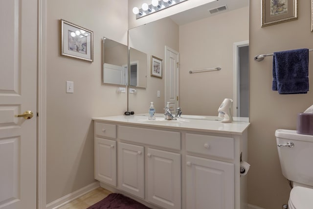 12183 Wildflower Ln, Huntley, IL 60142 - bathroom with toilet, vanity, and baseboards