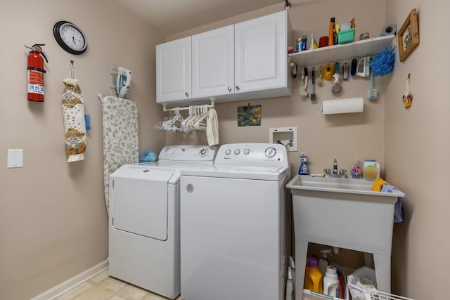 12183 Wildflower Ln, Huntley, IL 60142 - laundry area with washer and clothes dryer, cabinet space, and baseboards