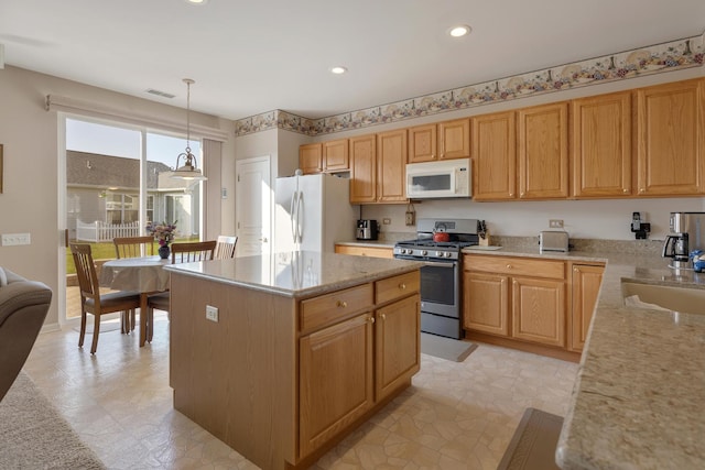 12183 Wildflower Ln, Huntley, IL 60142 - kitchen with white appliances, a kitchen island, light stone countertops, pendant lighting, and recessed lighting