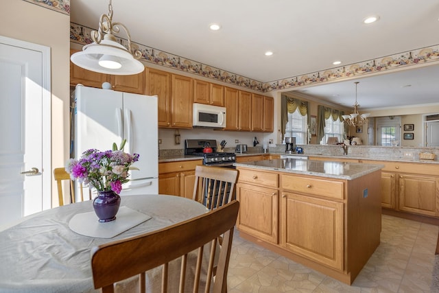 12183 Wildflower Ln, Huntley, IL 60142 - kitchen featuring white appliances, a chandelier, a kitchen island, pendant lighting, and a sink