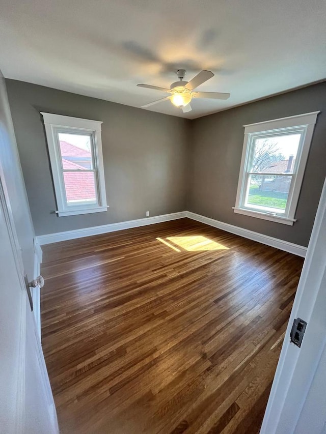 407 N William St, Joliet, IL 60435 - empty room with dark wood finished floors, baseboards, and ceiling fan