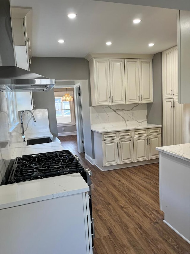 407 N William St, Joliet, IL 60435 - kitchen with wall chimney range hood, a sink, tasteful backsplash, recessed lighting, and dark wood-type flooring