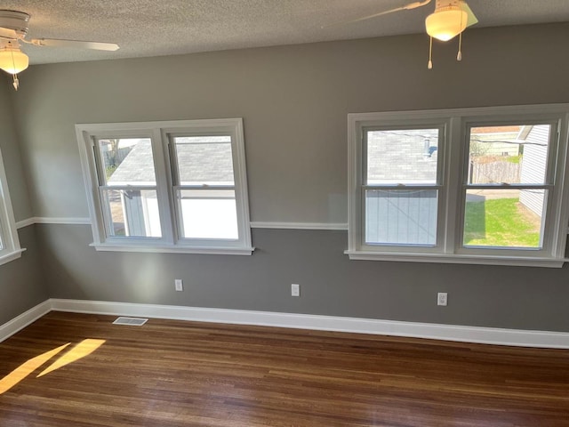 407 N William St, Joliet, IL 60435 - spare room with dark wood finished floors, ceiling fan, baseboards, and a textured ceiling