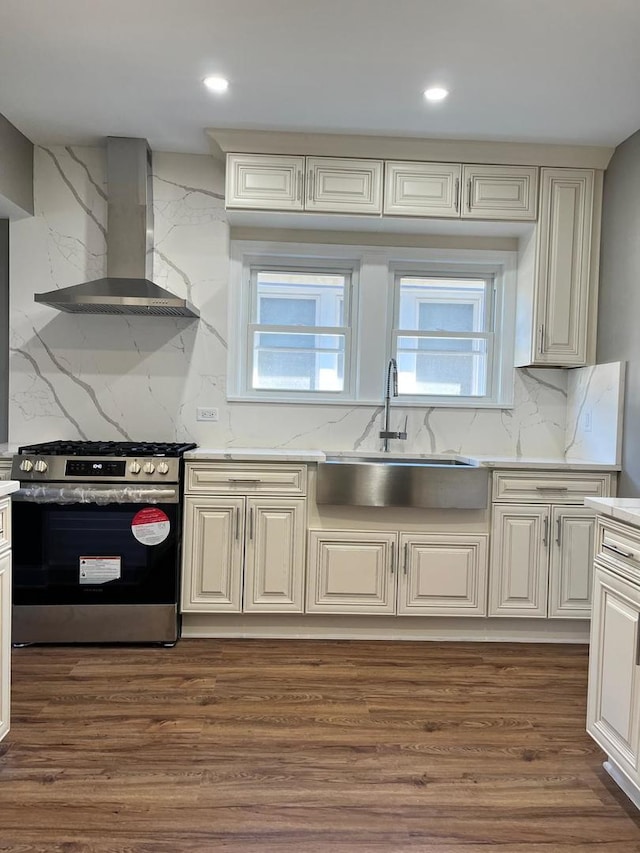407 N William St, Joliet, IL 60435 - kitchen with stainless steel range with gas stovetop, wall chimney exhaust hood, a sink, backsplash, and dark wood-type flooring