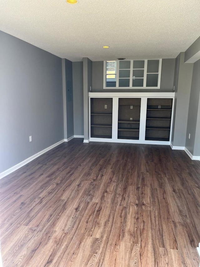 407 N William St, Joliet, IL 60435 - bar with a textured ceiling, wood finished floors, baseboards, and built in shelves