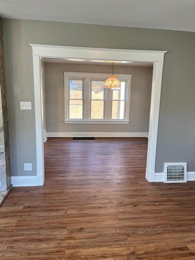 407 N William St, Joliet, IL 60435 - unfurnished dining area with baseboards and dark wood-type flooring