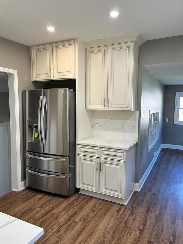 407 N William St, Joliet, IL 60435 - kitchen with stainless steel fridge with ice dispenser, dark wood finished floors, baseboards, light stone countertops, and recessed lighting