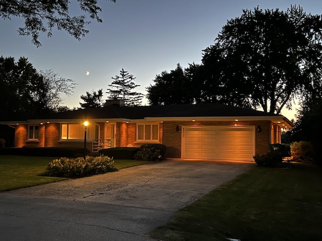 405 Farmington Ave, Joliet, IL 60435 - single story home featuring an attached garage, driveway, a chimney, brick siding, and a front lawn