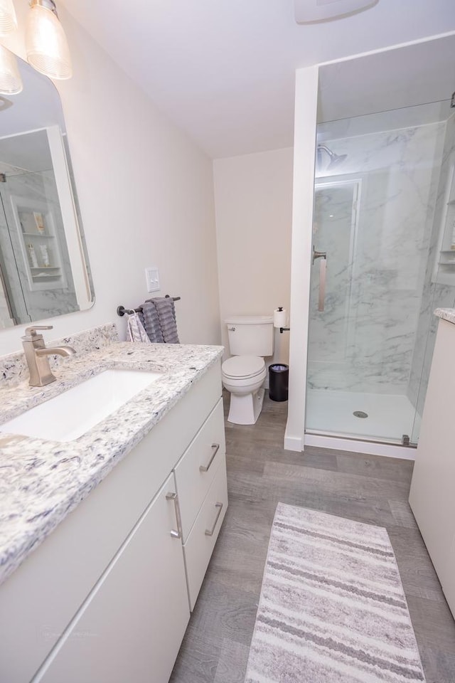 405 Farmington Ave, Joliet, IL 60435 - bathroom with vanity, a marble finish shower, toilet, and wood finished floors