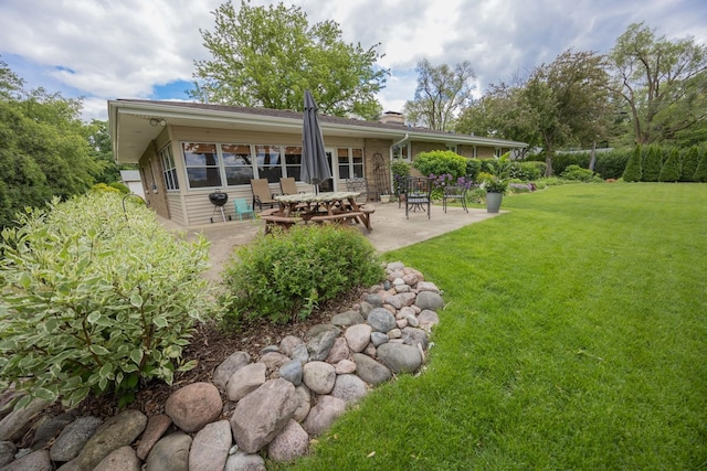 405 Farmington Ave, Joliet, IL 60435 - back of house featuring a patio area, a yard, and a chimney