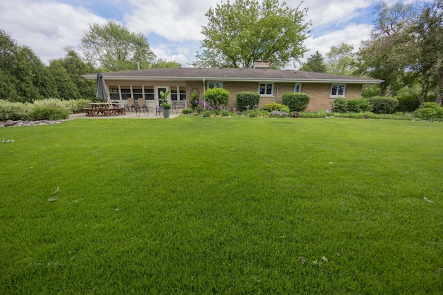 405 Farmington Ave, Joliet, IL 60435 - view of front of house with a patio area, a front yard, and a chimney