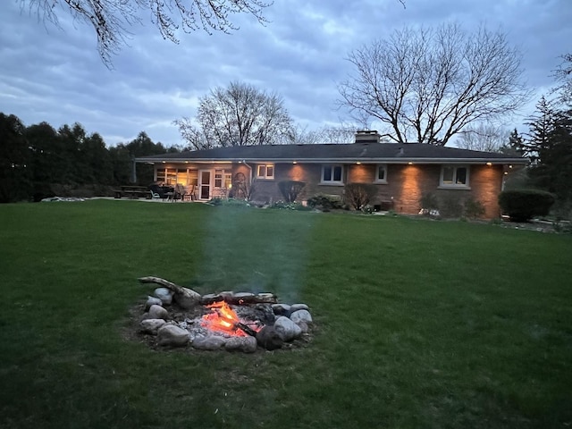 405 Farmington Ave, Joliet, IL 60435 - rear view of house featuring a fire pit, a yard, a chimney, and a patio