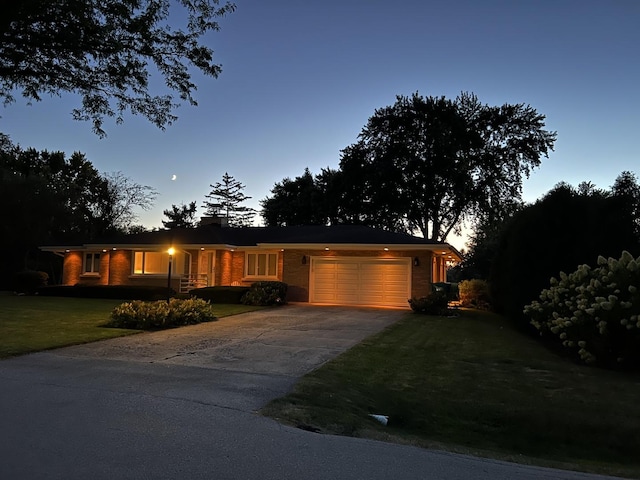 405 Farmington Ave, Joliet, IL 60435 - ranch-style house with a garage, a yard, driveway, and brick siding