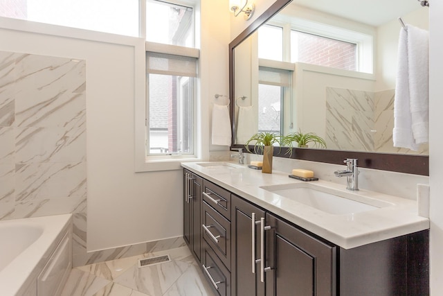 2823 N Oakley Ave Unit K, Chicago, IL 60618 - bathroom with marble finish flooring, plenty of natural light, double vanity, and baseboards