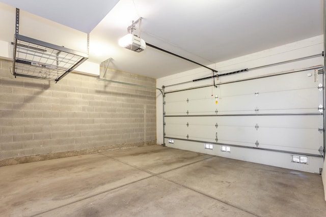 2823 N Oakley Ave Unit K, Chicago, IL 60618 - garage with a garage door opener and concrete block wall