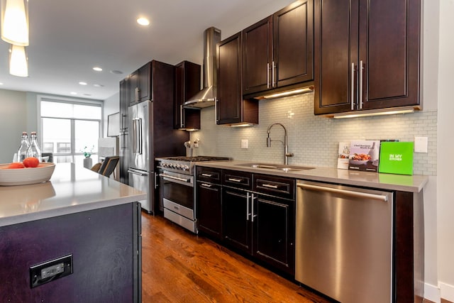 2823 N Oakley Ave Unit K, Chicago, IL 60618 - kitchen with premium appliances, a sink, wall chimney exhaust hood, dark wood finished floors, and backsplash