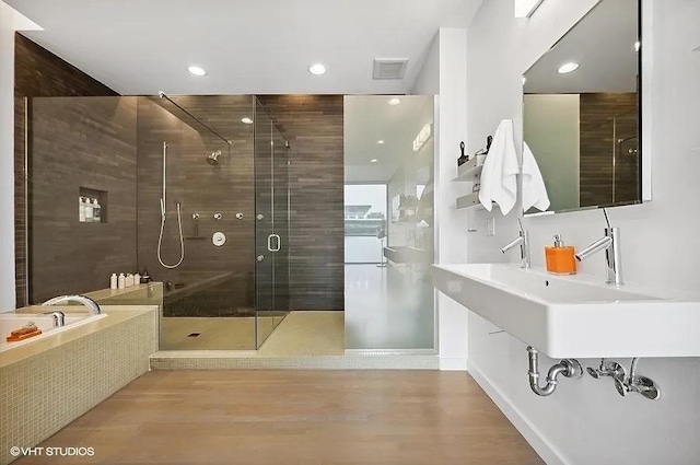 2157 W Division St Unit 401, Chicago, IL 60622 - full bathroom featuring a stall shower, wood finished floors, recessed lighting, a sink, and a bath
