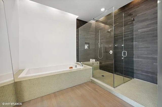 2157 W Division St Unit 401, Chicago, IL 60622 - bathroom with a bath, a shower stall, and wood finished floors