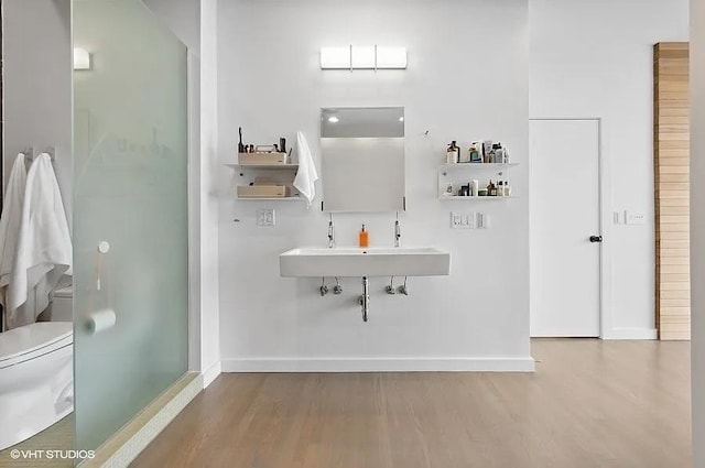 2157 W Division St Unit 401, Chicago, IL 60622 - bathroom with wood finished floors, toilet, baseboards, and a sink