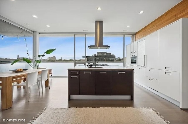 2157 W Division St Unit 401, Chicago, IL 60622 - kitchen featuring a sink, white cabinetry, island exhaust hood, modern cabinets, and a kitchen island