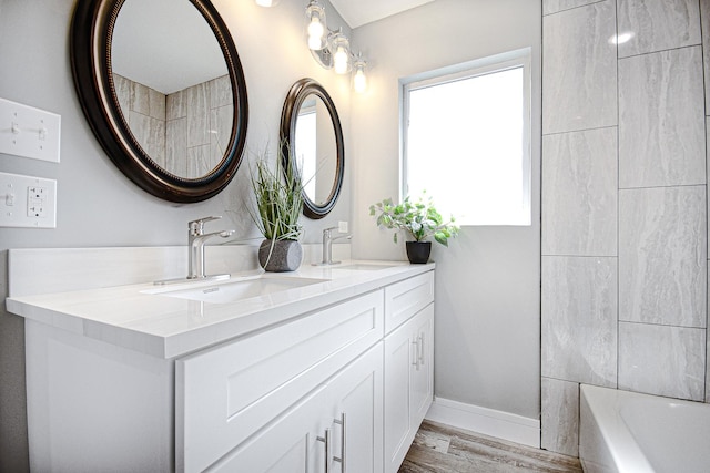 34 W 142nd St, Harvey, IL 60426 - bathroom with double vanity, wood finished floors, and baseboards
