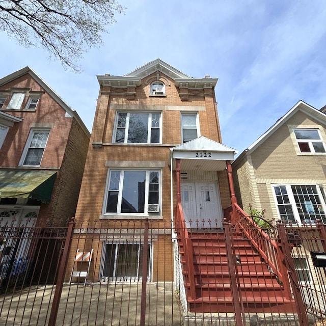 2322 S Trumbull Ave, Chicago, IL 60623 - view of front of house featuring brick siding, a fenced front yard, and a gate