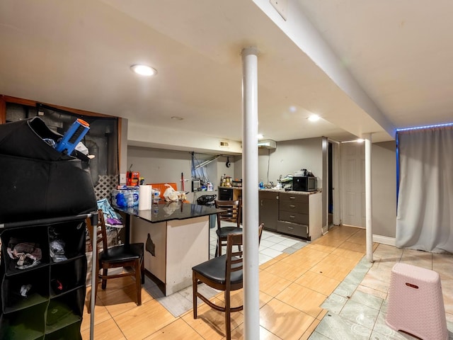 2322 S Trumbull Ave, Chicago, IL 60623 - kitchen with a peninsula, dark countertops, and a breakfast bar
