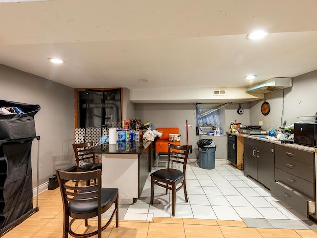 2322 S Trumbull Ave, Chicago, IL 60623 - kitchen featuring a breakfast bar, recessed lighting, and light tile patterned floors