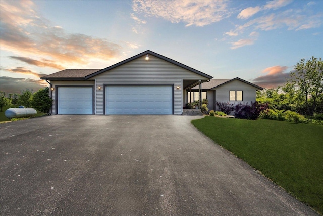 5057 Kasch Rd, Pecatonica, IL 61063 - ranch-style home with driveway, a lawn, and a garage